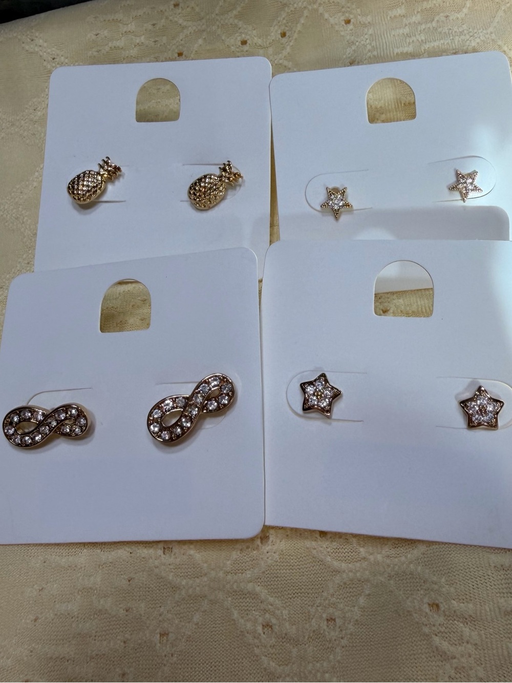 Four pairs of dainty gold tone earring studs